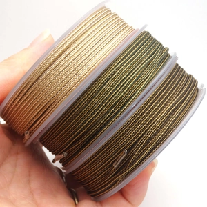 Detailed macro view of 1.4mm and 1.7mm dual-tone braided cord spools for jewelry DIY