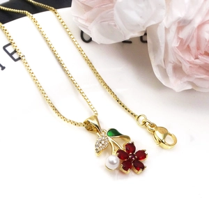 Exquisite gold plated copper floral necklace with red gems and white pearls on box chain