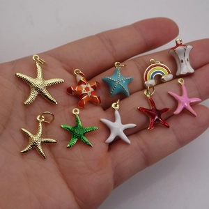 Colorful mixed starfish and rainbow charms set in hand to show actual scale and size