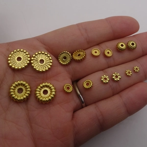 Assorted gold-plated spacer beads in flower and gear shapes for DIY jewelry making
