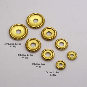 Detail view of four sizes of gold-plated copper spacers with textured edges for DIY jewelry