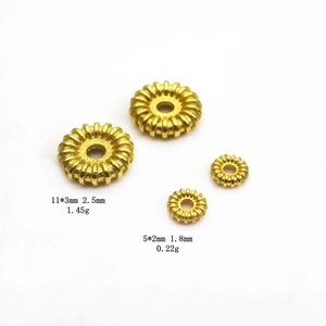 Macro detail of gold plated gear beads showing dimensions and radial texture for jewelry