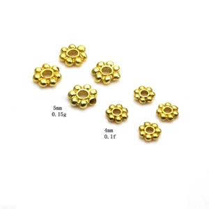 Detailed macro view of gold flower-shaped metal spacer beads for DIY jewelry making