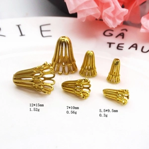Detailed macro of vintage gold-plated trumpet flower bead caps in three varied sizes