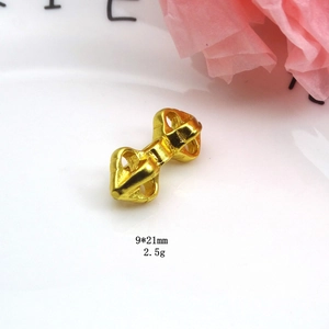 Macro view of gold-plated Vajra pestle pendant measuring 9x21mm and weighing 2.5g