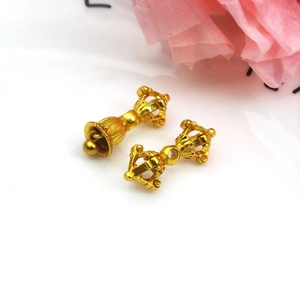 Detailed view of matte gold-plated Vajra Bell and Pestle charms for DIY jewelry making