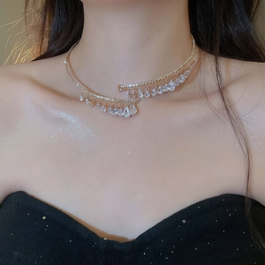 Ras du cou doré élégant avec pendentifs en zircon goutte sur peau scintillante.