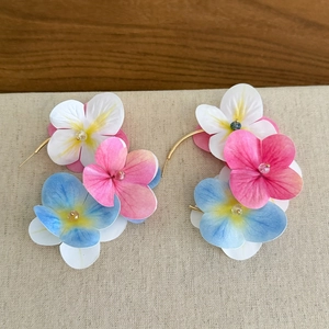 Detailed close-up of vibrant colorful fabric flower C-shaped hoop earrings for summer vacation