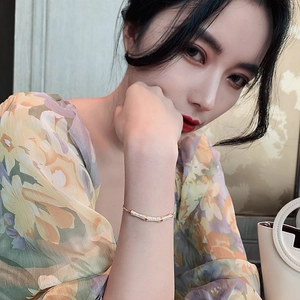 Elegant gold bamboo joint bracelet with shimmering crystal accents on model's wrist