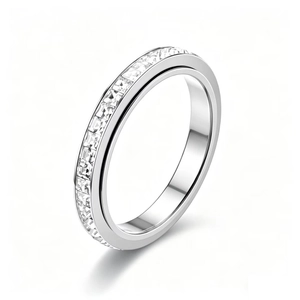 Close-up of rotating titanium steel ring with single row of clear cubic zirconia
