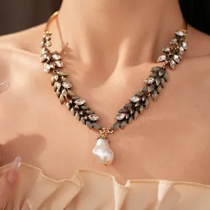 Elegant vintage leaf necklace featuring marquise rhinestones and baroque pearl pendant