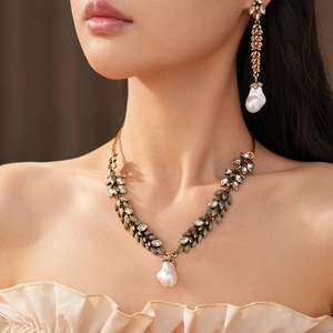 Elegant vintage leaf jewelry set with sparkling rhinestones and baroque pearls on model