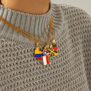 Close-up of colorful enamel world map necklaces worn over a stylish grey knit sweater