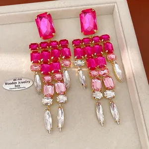 Close-up of elegant vintage hot pink crystal tassel earrings displayed in a jewelry tray