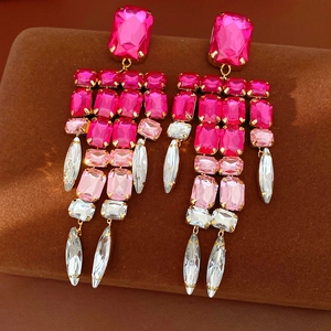 Macro detail of vintage pink crystal tassel earrings with gold-tone claws