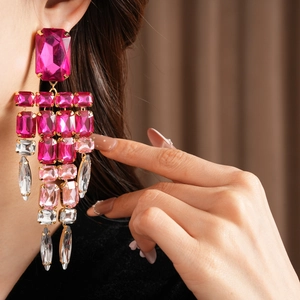 Close-up of luxury vintage pink rhinestone tassel dangling earrings worn by a model
