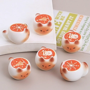 Miniature ceramic Christmas cat figurines with festive snowflake and gingerbread patterns