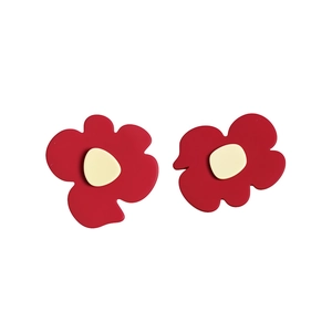 Pair of red geometric flower-shaped hair clips with cream centers on white background