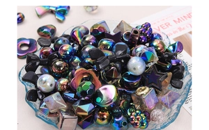 Close-up of colorful electroplated acrylic beads in mixed shapes for DIY jewelry making