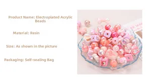 Macro detail of pink electroplated and acrylic DIY beads in a glass tray for jewelry making