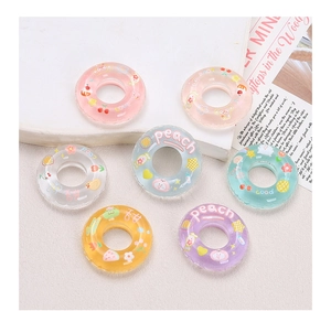 Flat lay of colorful macaron resin swim ring charms for DIY crafts and decor