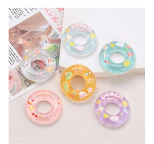 Macro shot of colorful resin swimming ring charms with cute fruit patterns for DIY crafts