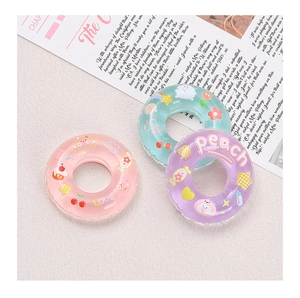 Mini transparent swimming ring charms with Love and Peach text on a magazine