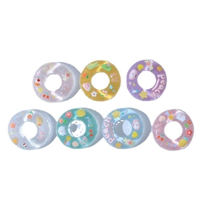Set of 7 colorful translucent mini PVC swimming rings with assorted fruit and cartoon prints
