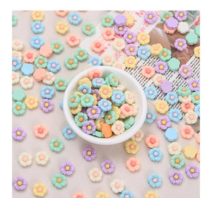 Close-up of colorful resin flower cabochons for DIY crafts in candy macaron colors
