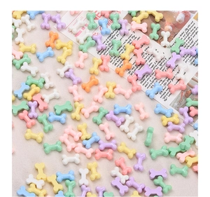 Macro shot of colorful bone-shaped resin beads in pastel colors for DIY jewelry making