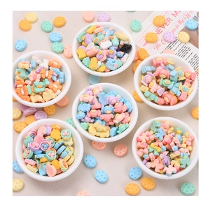 Macro shot of colorful resin DIY charms in white bowls for handmade craft accessories