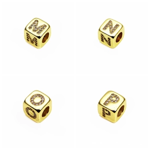 Macro detail of 6mm gold cubic beads with micro-paved zircon letters M, N, O, and P