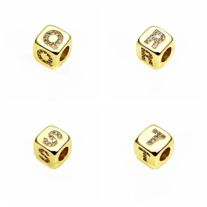 Macro shot of 6mm gold plated square alphabet beads with micro-set cubic zirconia stones