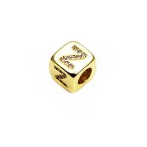 Macro detail of cube-shaped gold plated bead with micro-pave zircon letter Z design