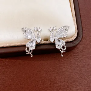 Elegant silver butterfly ear clips with sparkling zircons displayed on a luxury jewelry box