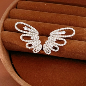 Sparkling cubic zirconia butterfly wing ear clips in a luxury velvet jewelry box.