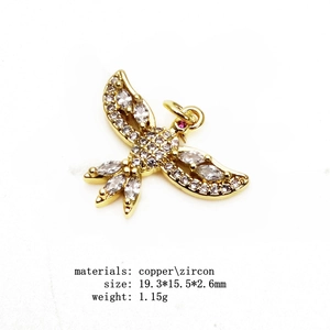 Gold bird pendant with sparkling zircons for necklaces and bracelets on white background