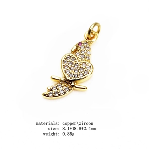 Detailed macro view of heart-shaped copper charm with pave-set white zircons and red gem