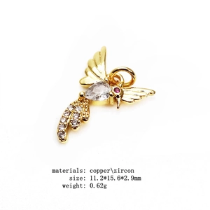 Detailed macro view of hummingbird charm in gold finish with micro-set zircon accents