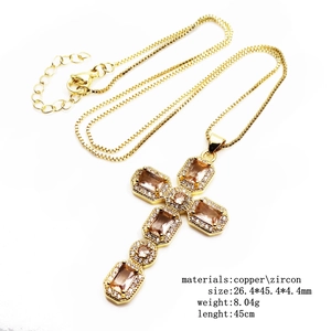 Adjustable cross necklace with champagne zircons in gold plating on white background