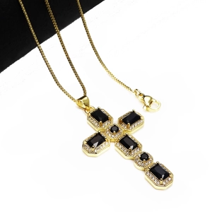Detail of gold cross pendant with black zircon stones and micro-set white crystals