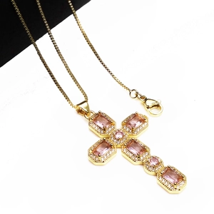 Elegant gold cross pendant necklace with pink gemstones and adjustable chain for women
