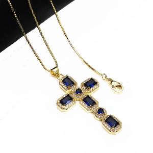 Golden cross necklace with blue gems and cubic zirconia, elegant minimalist jewelry design