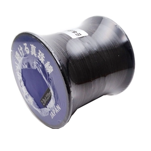 Macro detail of 0.235mm black nylon pearl string on reel for DIY jewelry making