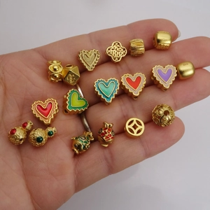 Golden DIY jewelry beads collection including heart, lotus, and lucky charms for bracelets