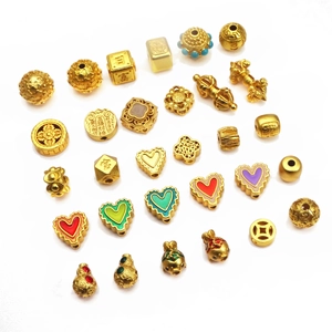 Assorted gold-plated heart beads and Chinese fortune charms for DIY jewelry making