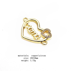 Macro detail of a 25x18mm gold Mama heart connector charm with micro-pave zircons