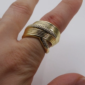 Macro detail of multi-layer 14k gold plated wide ring with pave cubic zirconia stones