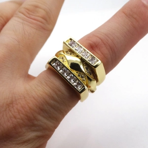 Three-piece set of geometric layered rings in 14k gold finish with pavé zircon stones