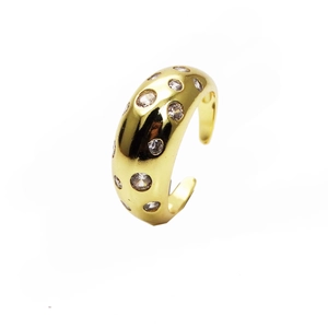 Detailed view of the gold-plated wide band ring with inlaid cubic zirconia accents